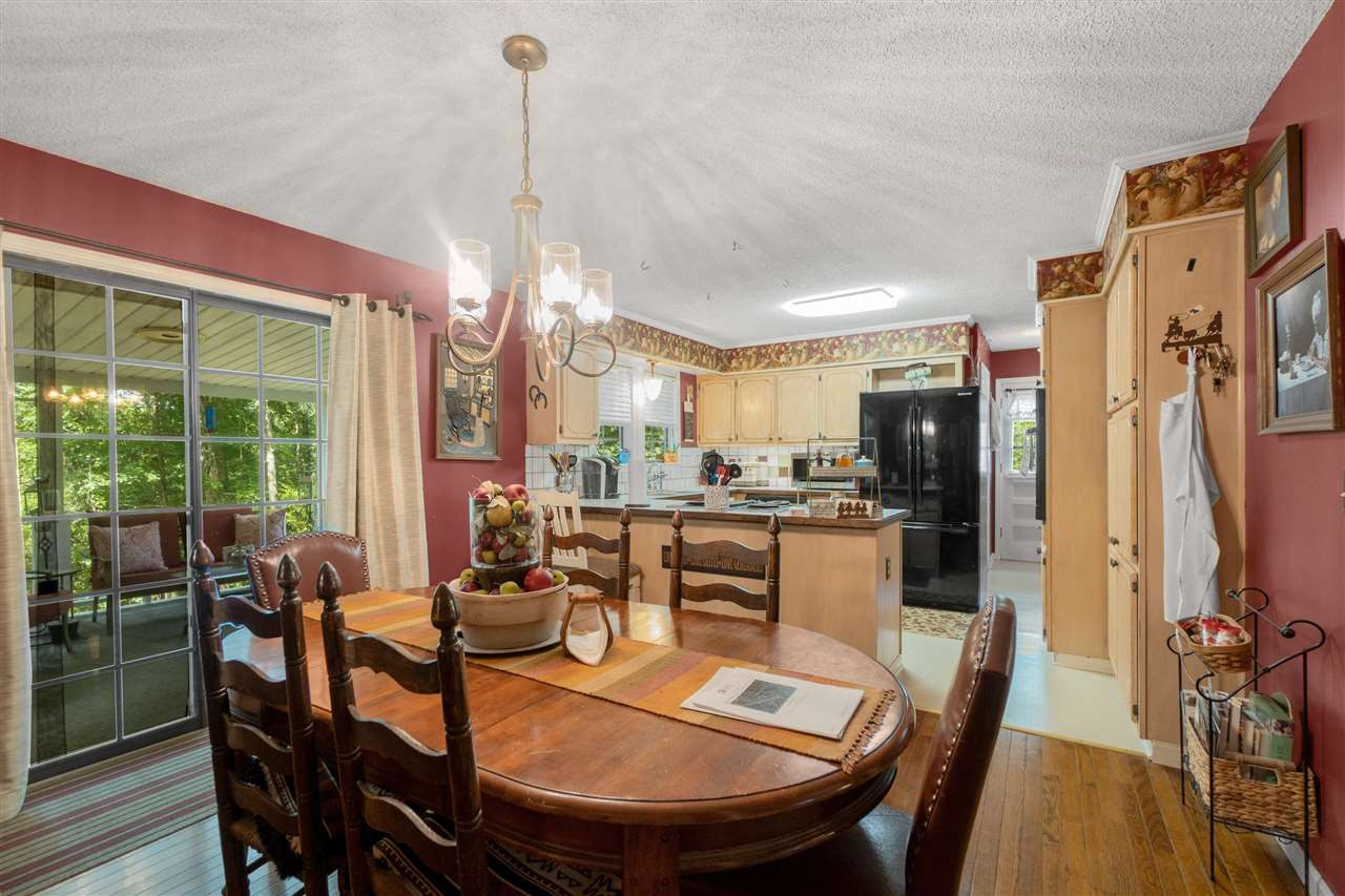 4840 Clifford Road Luray, TN 38352 - Photo 8 of 23 a dining room with furniture a chandelier and wooden floor
