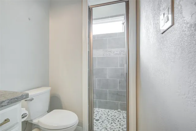 a white toilet sitting next to a bathroom sink