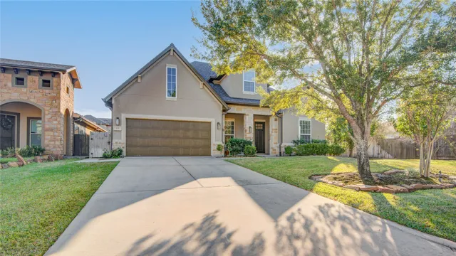 a front view of a house with a yard and trees