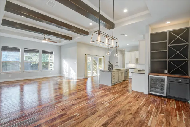 a kitchen view with wooden floor cabinetry and a sink