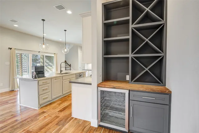a view of an empty room with window and fire place