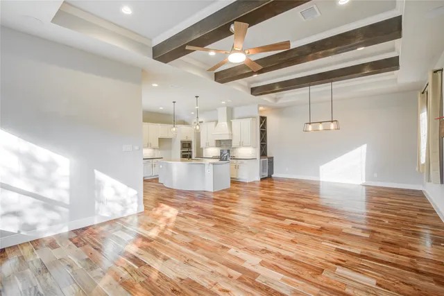 a large kitchen with kitchen island a counter top space a sink stainless steel appliances and cabinets