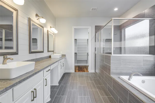 a bathroom with a bathtub and a shower