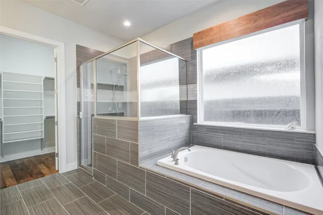 a bathroom with a glass shower door and mirror