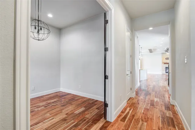 a view of a room with wooden floor