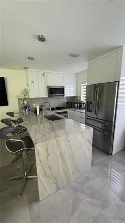 a kitchen with a sink a stove and refrigerator
