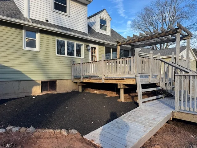 a view of backyard with deck and wooden floor