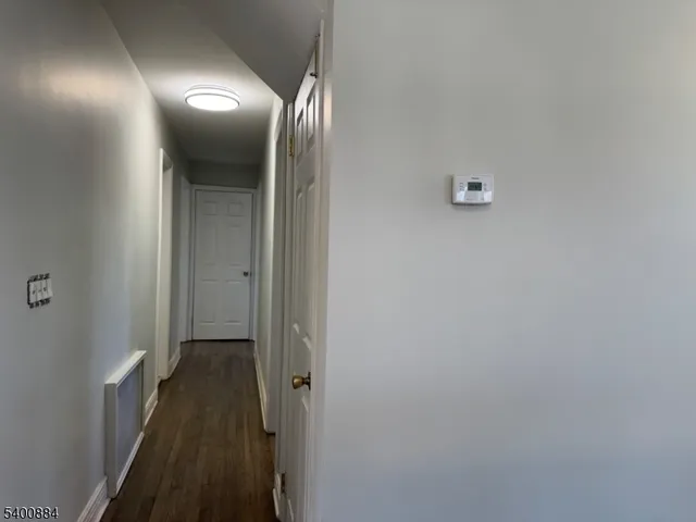 a view of a hallway with a wooden door