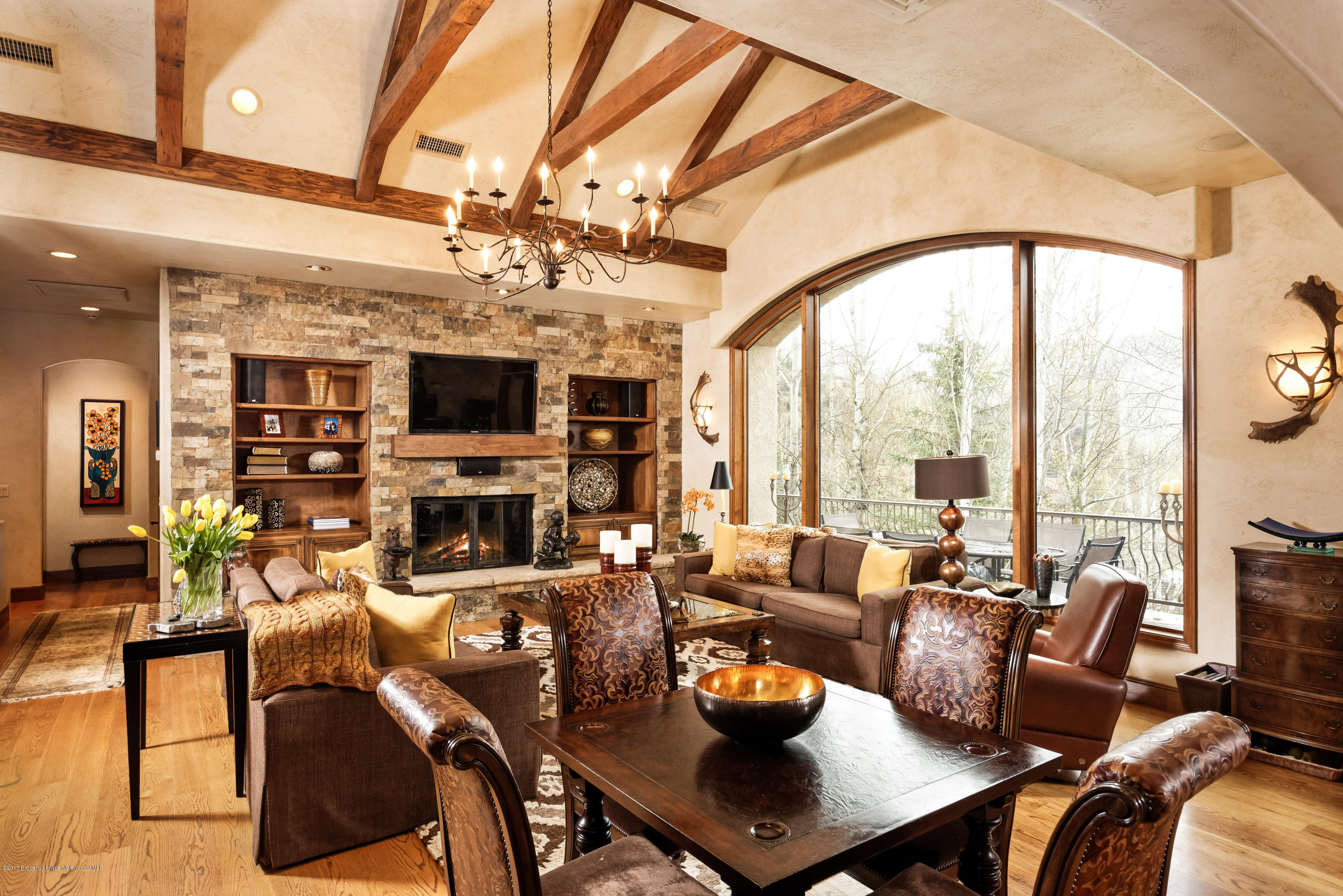 a living room with fireplace furniture and a large window