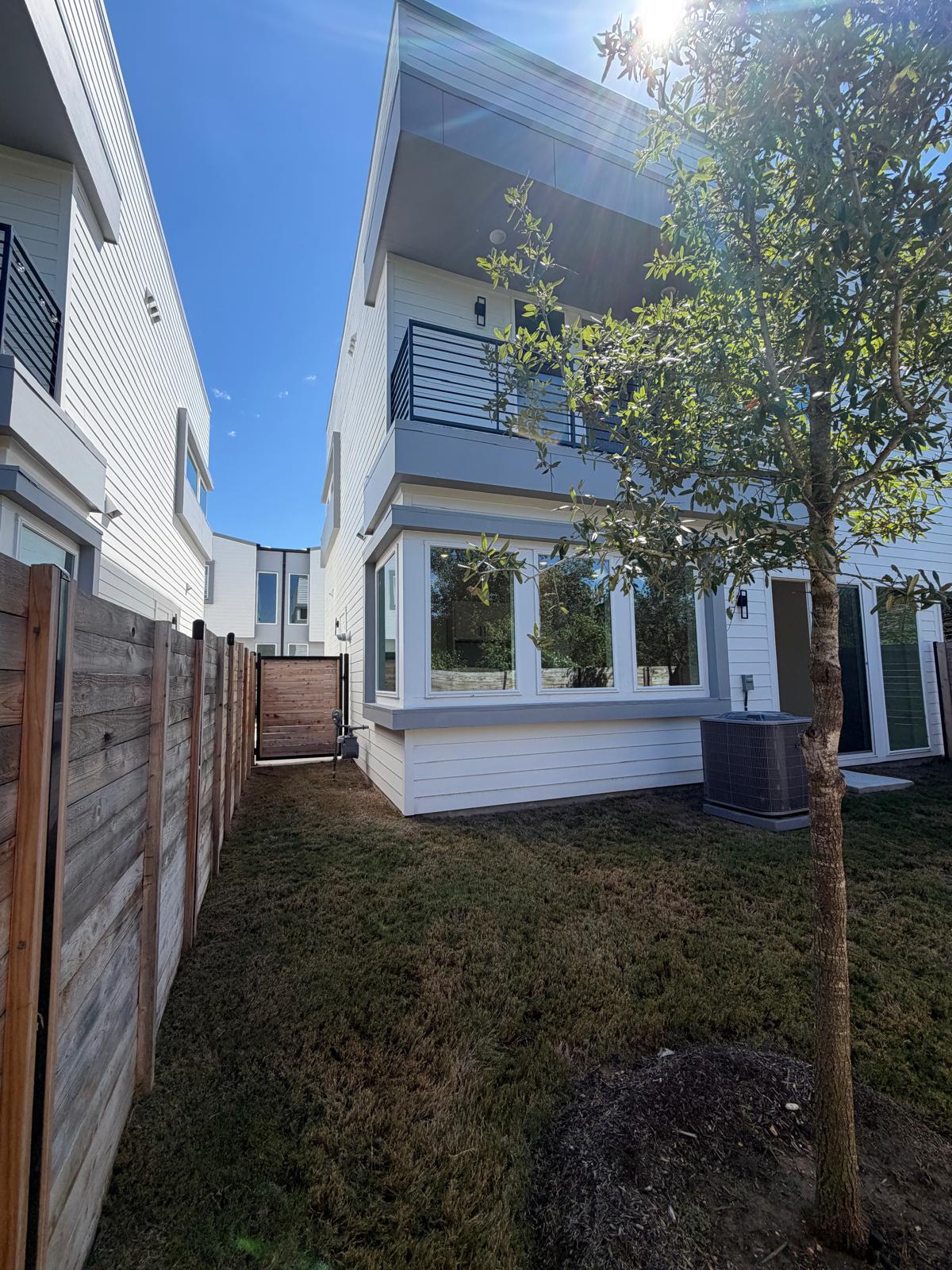 2000 Riverside Farms Road, Unit 12101 Austin, TX 78741 - Photo 14 of 33 A private fenced backyard features clean modern siding and a multi-level balcony design.