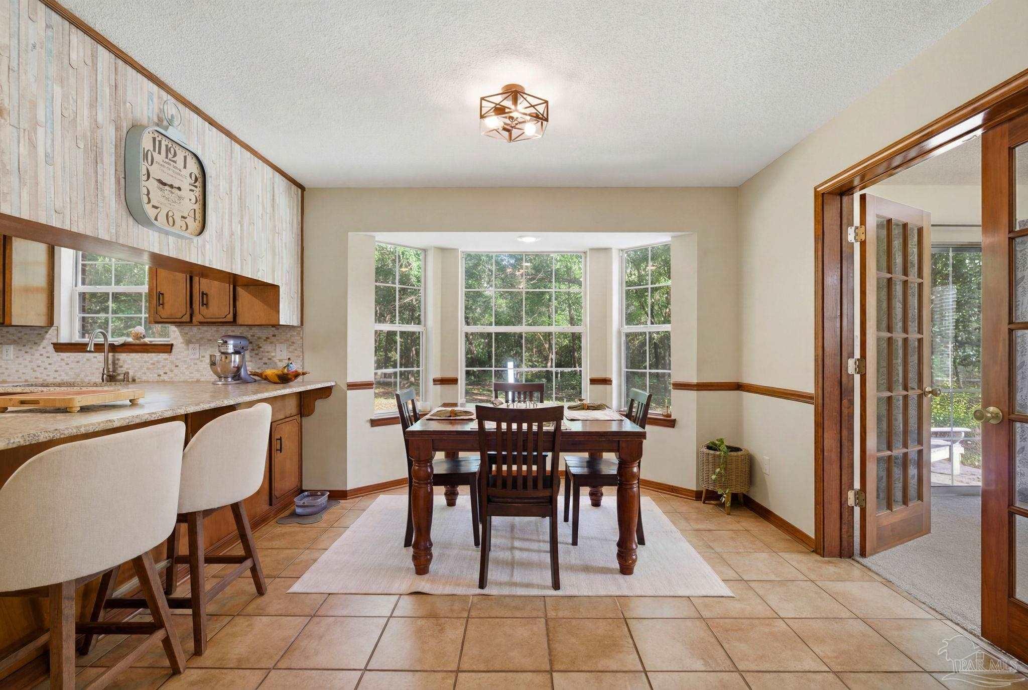 6870 Martin Road Milton, FL 32570 - Photo 9 of 48 a view of a dining room with furniture window and outside view