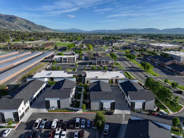 220 Spring Creek Parkway Providence, UT 84332 - Photo 13 of 17 Aerial perspective showcasing a structured development with multiple buildings and surrounding infrastructure