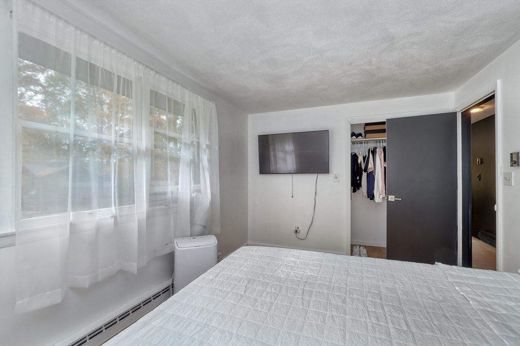 38 Appleton Street Saugus, MA 01906 - Photo 18 of 38 a bedroom with a bed and a glass door shower