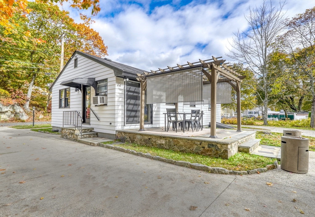 38 Appleton Street Saugus, MA 01906 - Photo 29 of 38 a backyard of a house with table and chairs and potted plants