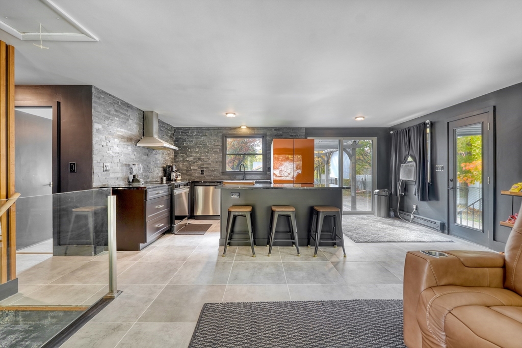 38 Appleton Street Saugus, MA 01906 - Photo 4 of 38 a dining hall with stainless steel appliances granite countertop a couch and a living room view