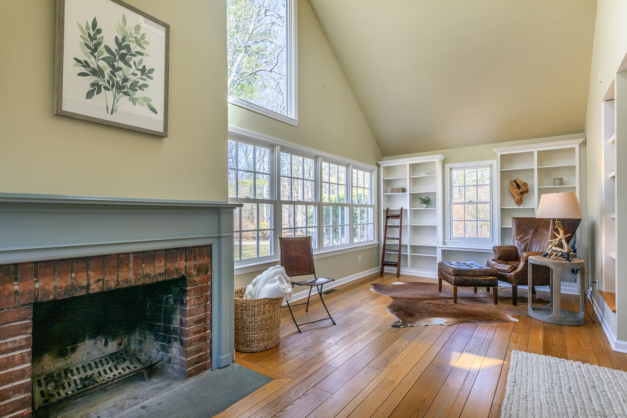 40 Camps Flat Road Kent, CT 06785 - Photo 15 of 26 a living room with furniture a fireplace and a floor to ceiling window