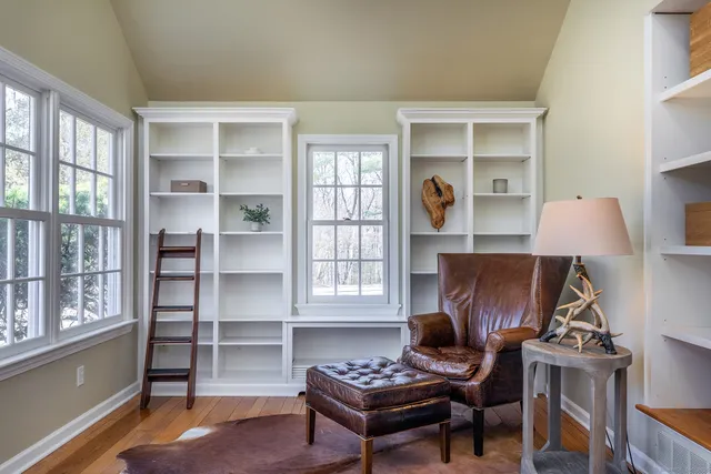 a living room with furniture a window and a piano