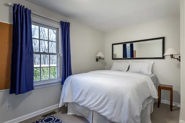 a bedroom with a bed and window