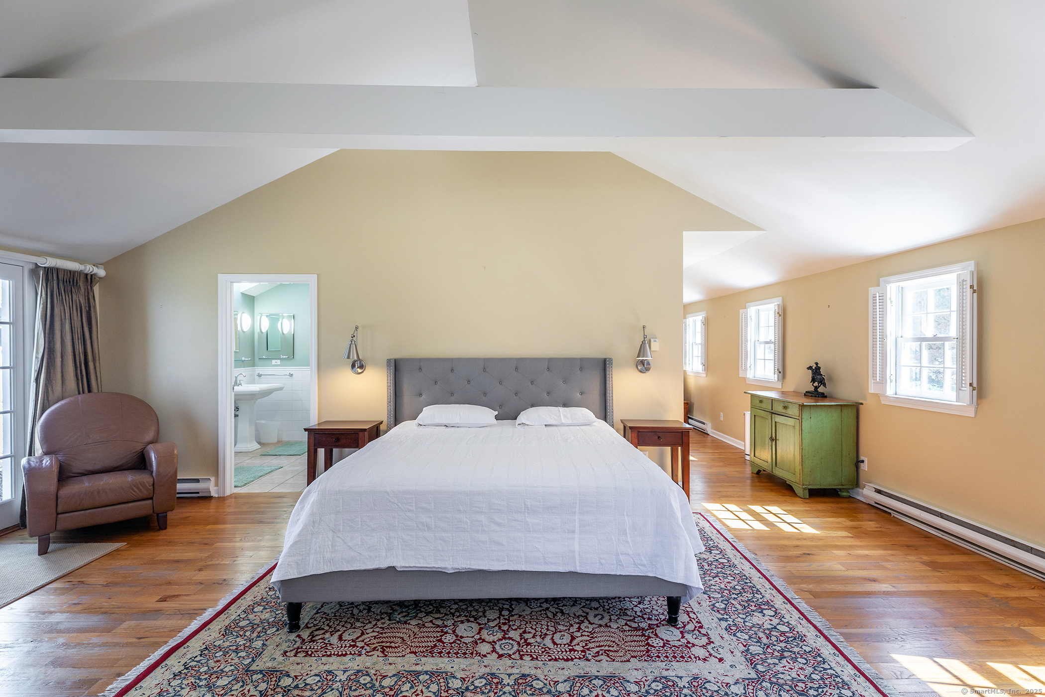 40 Camps Flat Road Kent, CT 06785 - Photo 17 of 26 a large bedroom with a bed and wooden floor