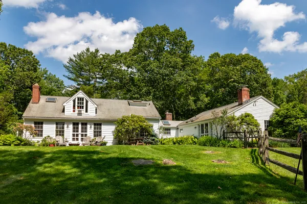 a front view of house with yard and green space
