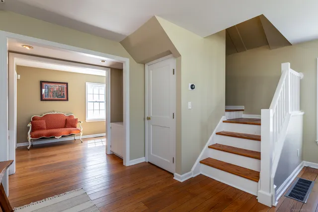 a room with wooden floor and furniture