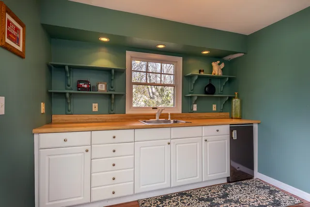 a view of cabinets a sink and a window in a room