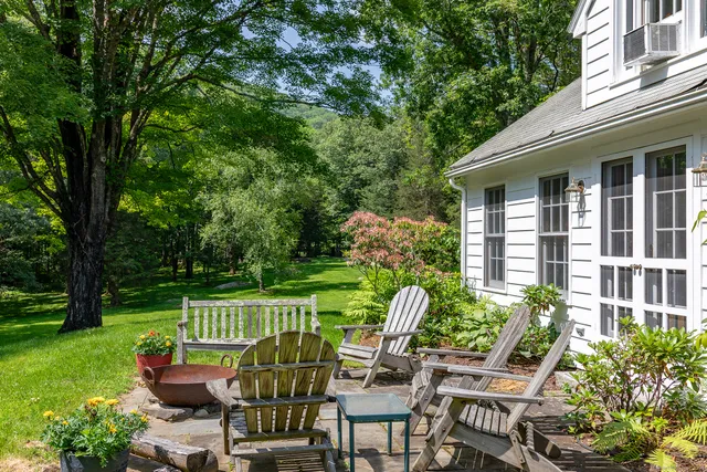 a view of a chair and tables in the backyard