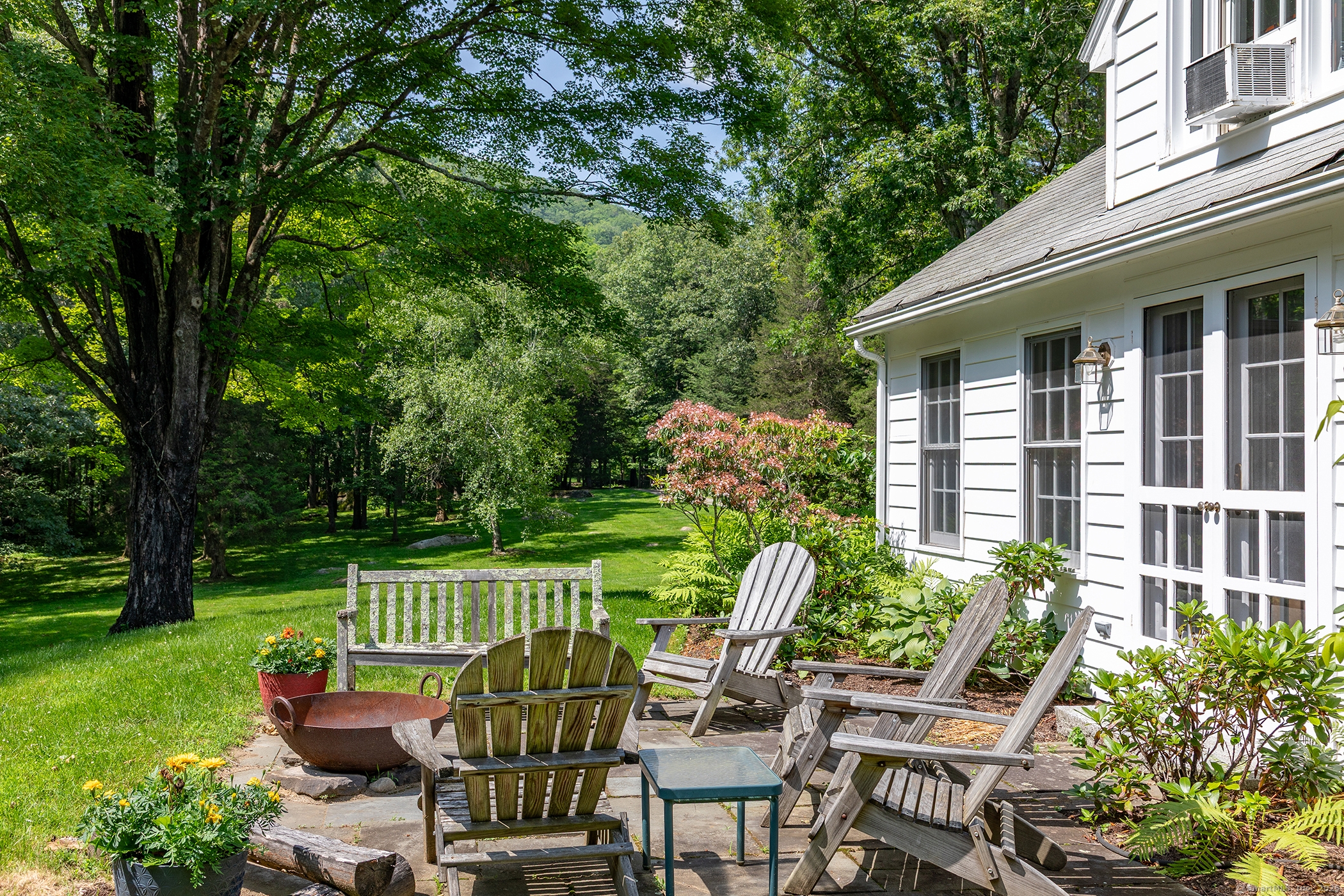 40 Camps Flat Road Kent, CT 06785 - Photo 4 of 26 a view of a chair and tables in the backyard