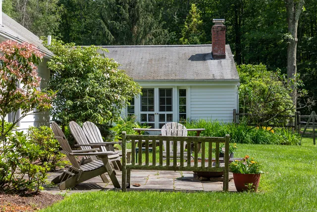 a view of a chair and table in the garden