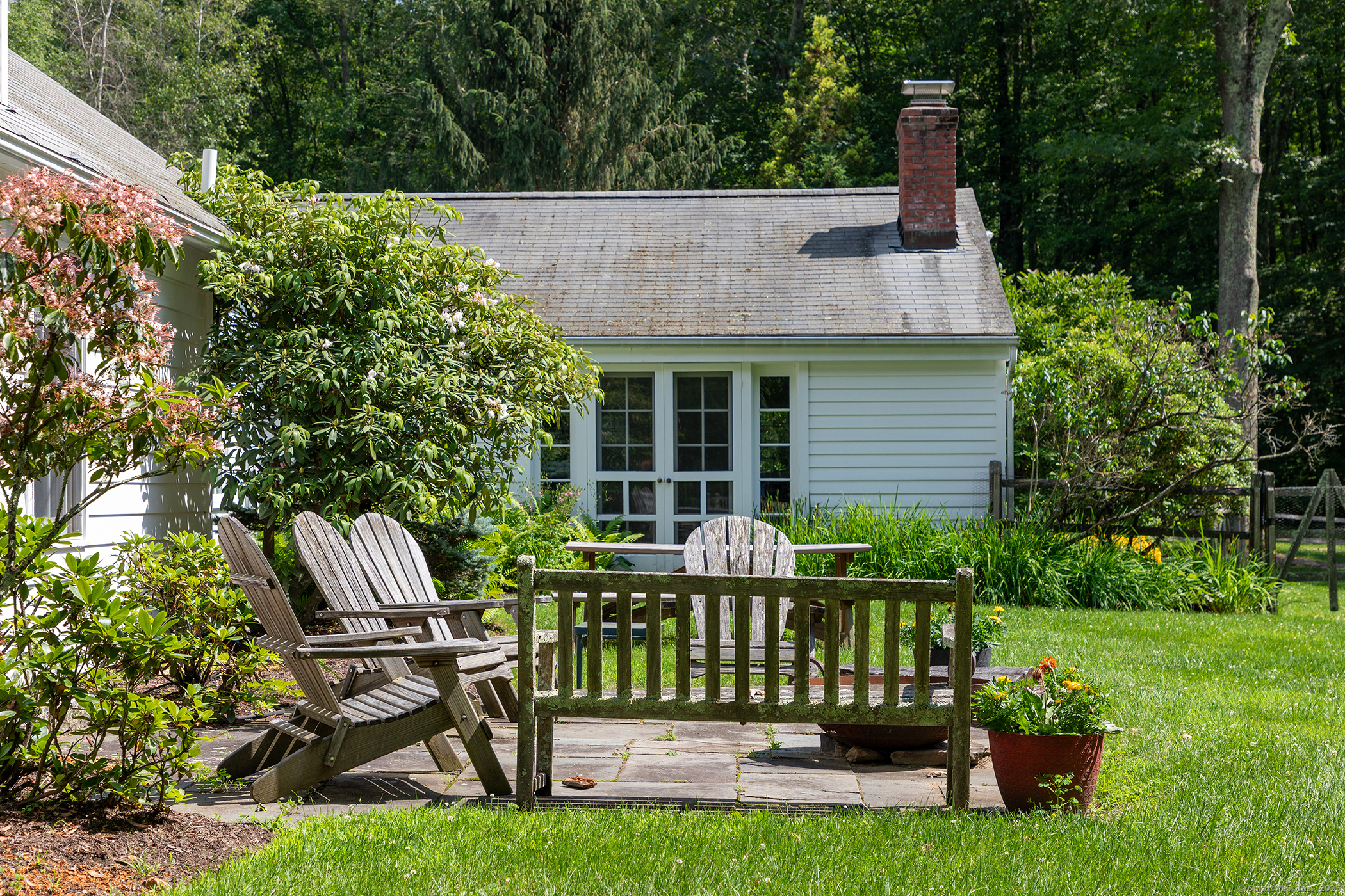 40 Camps Flat Road Kent, CT 06785 - Photo 5 of 26 a view of a chair and table in the garden