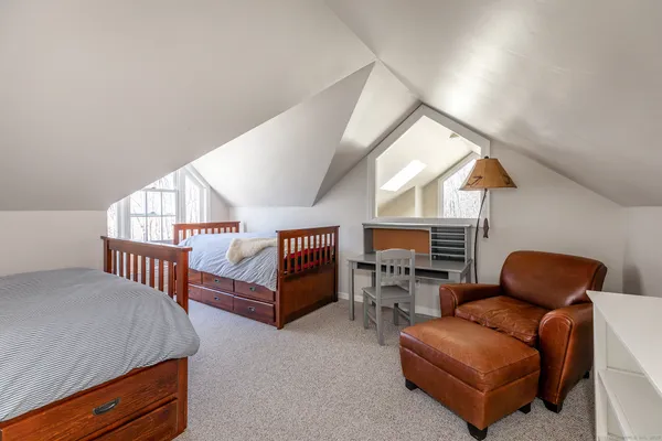 a bedroom with furniture and a window