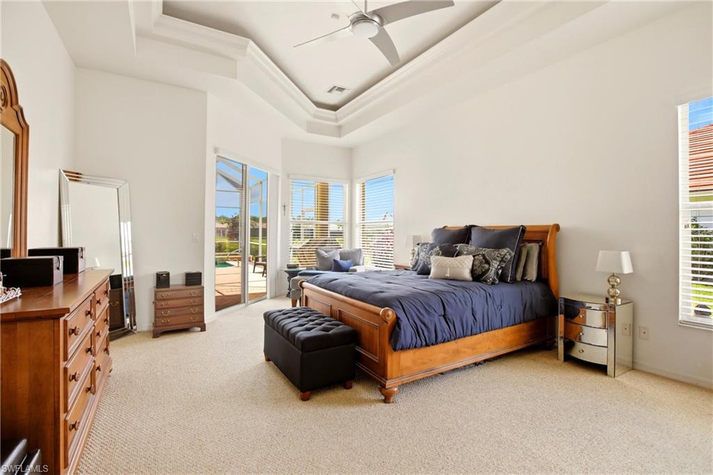 10815 Phoenix Way Naples, FL 34119 - Photo 16 of 40 a spacious bedroom with a bed and furniture