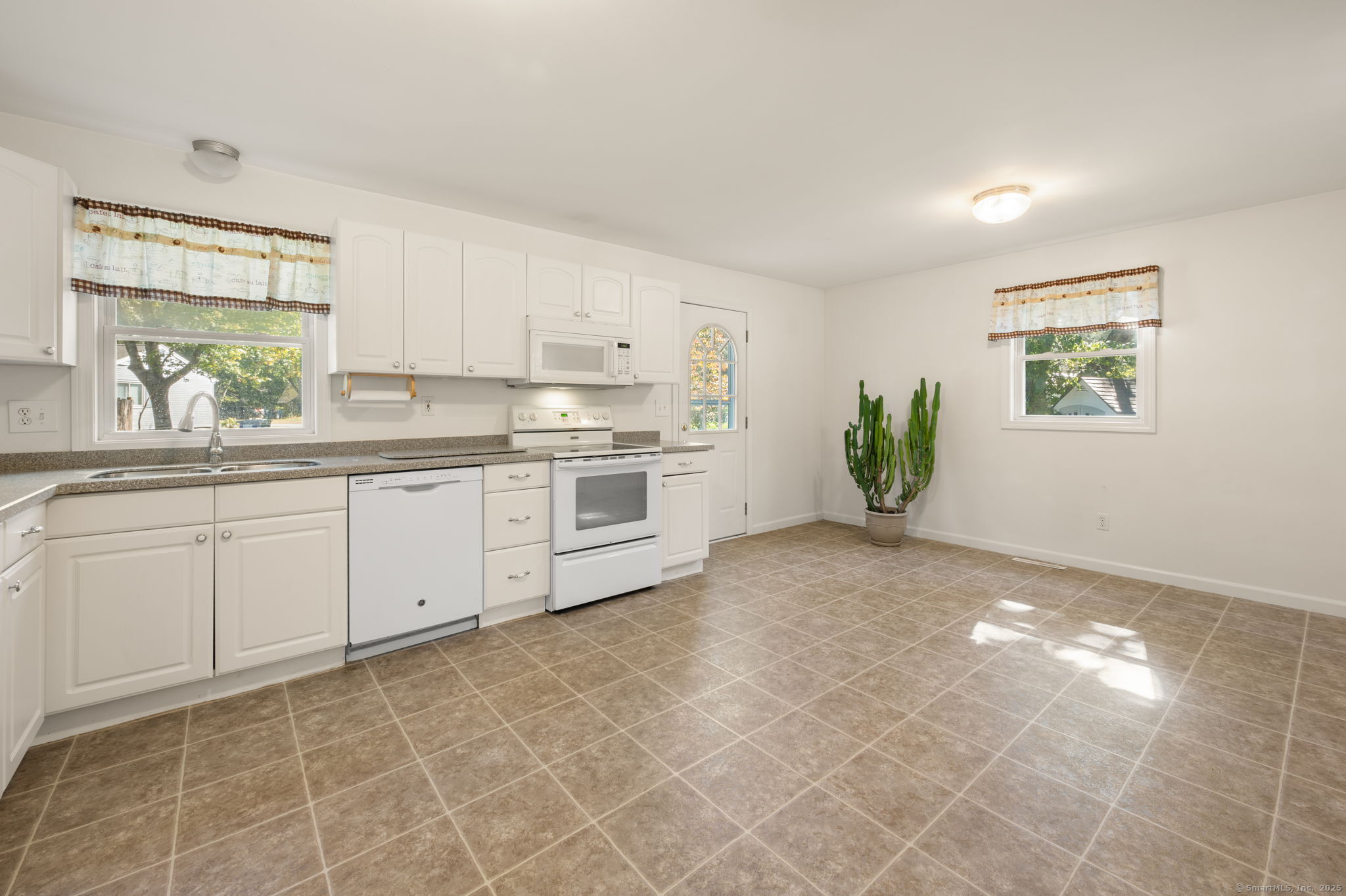 6 Sunset Road Gales Ferry, CT 06335 - Photo 6 of 23 a kitchen with a cabinets a sink a window and stainless steel appliances