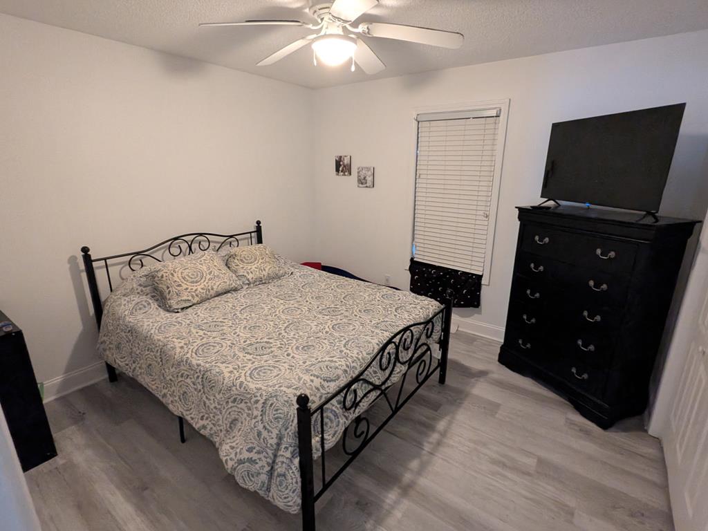 531 Philadelphia Drive Jasper, GA 30143 - Photo 26 of 43 a bedroom with a bed and a flat tv screen on a dresser