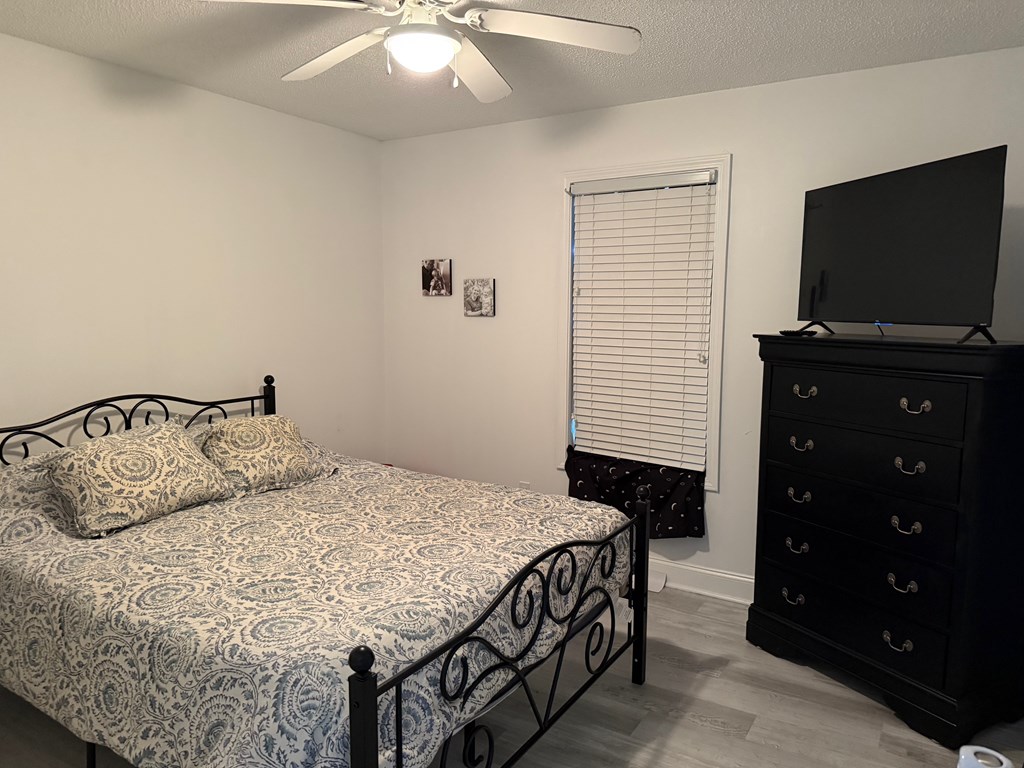 531 Philadelphia Drive Jasper, GA 30143 - Photo 10 of 43 a bedroom with a bed and a flat tv screen on dresser