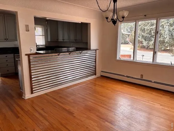 a kitchen view with wooden floor and a sink