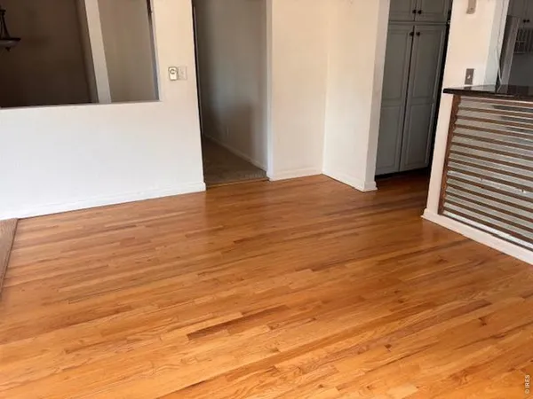 a view of a room with wooden floor