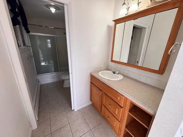 a bathroom with a sink a mirror and vanity