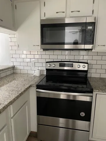 a stove top oven sitting inside of a kitchen