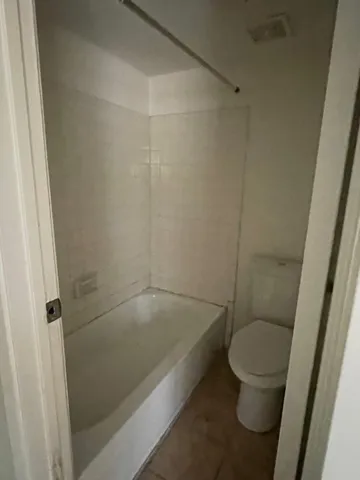 a bathroom with a bathtub and toilet