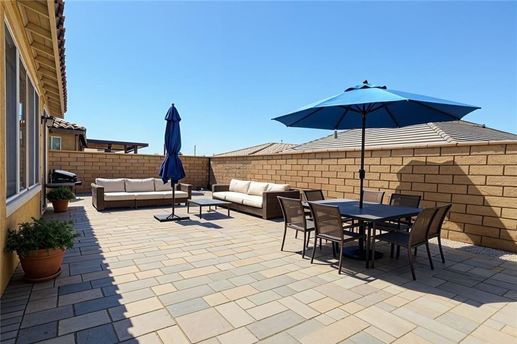 43885 Arancia Way Indio, CA 92203 - Photo 12 of 22 an outdoor space with furniture and umbrella