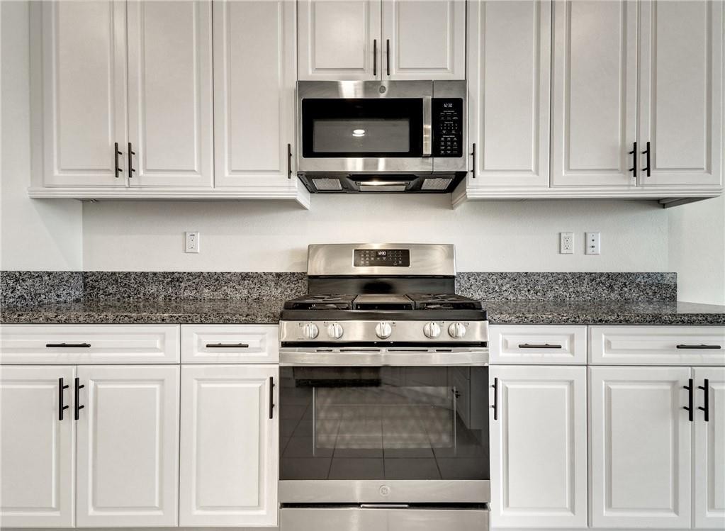 43885 Arancia Way Indio, CA 92203 - Photo 4 of 22 a kitchen with granite countertop white cabinets and stainless steel appliances