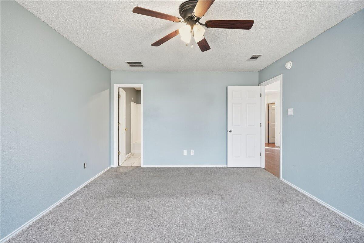 6214 6th Street Lubbock, TX 79416 - Photo 12 of 21 an empty room with chandelier fan