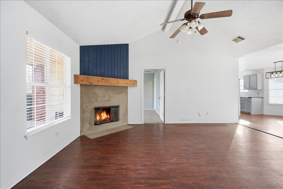 6214 6th Street Lubbock, TX 79416 - Photo 2 of 21 a view of a livingroom with a fireplace wooden floor and window