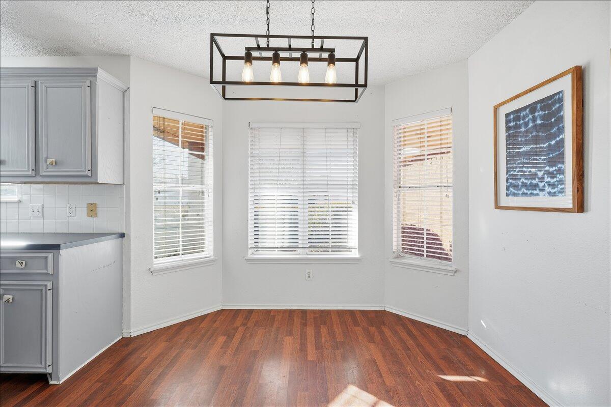 6214 6th Street Lubbock, TX 79416 - Photo 4 of 21 a view of an empty room with a window and wooden floor