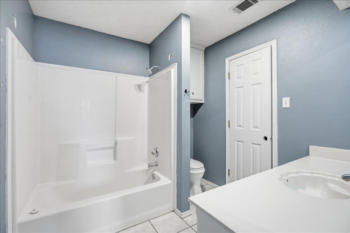 6214 6th Street Lubbock, TX 79416 - Photo 9 of 21 a bathroom with a bathtub and a sink