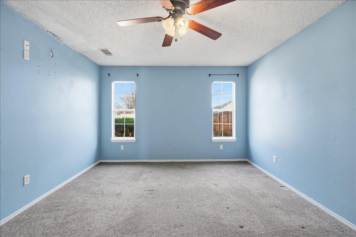 6214 6th Street Lubbock, TX 79416 - Photo 10 of 21 a view of room with window and ceiling fan