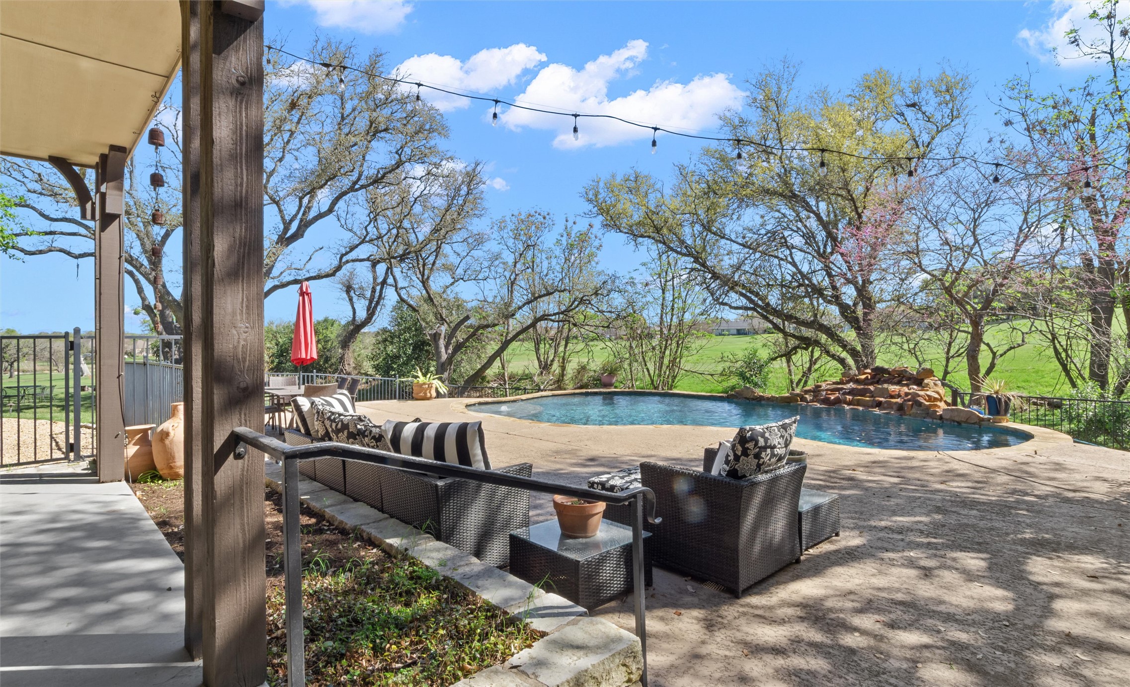 913 South Ridge Road Salado, TX 76571 - Photo 31 of 40 Gorgeous outdoor living with pool, deck, and wrought iron fencing.
