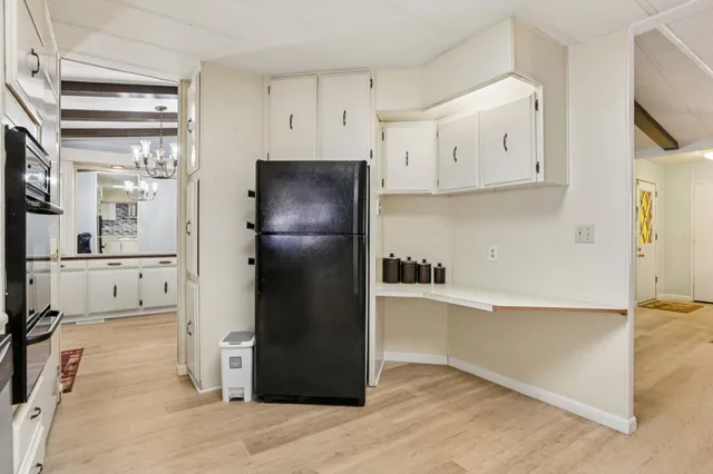 a kitchen with stainless steel appliances a refrigerator and a stove
