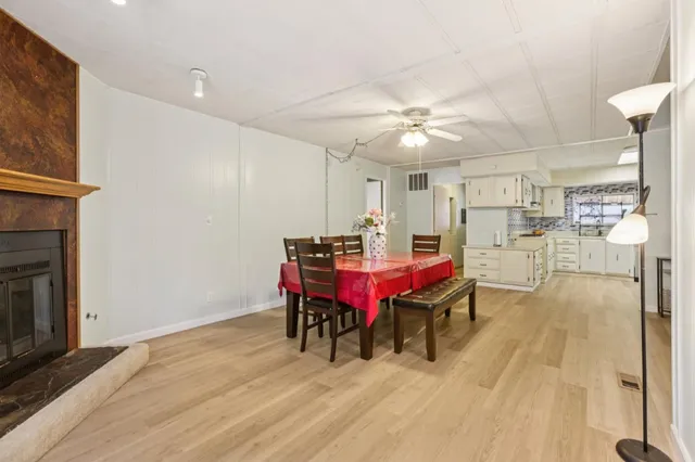 a room with stainless steel appliances kitchen island granite countertop furniture and a fireplace